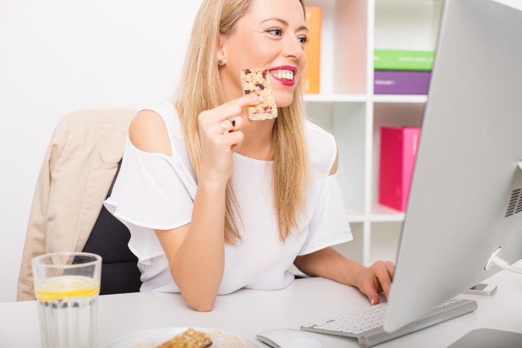 woman eating snack in her workplace