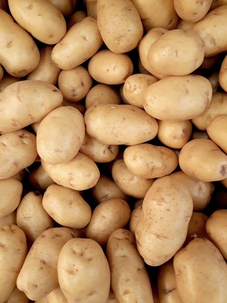 bunch of unpeeled potatoes