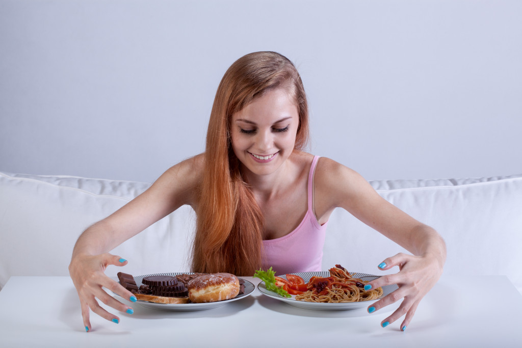 woman about to eat two plates of food