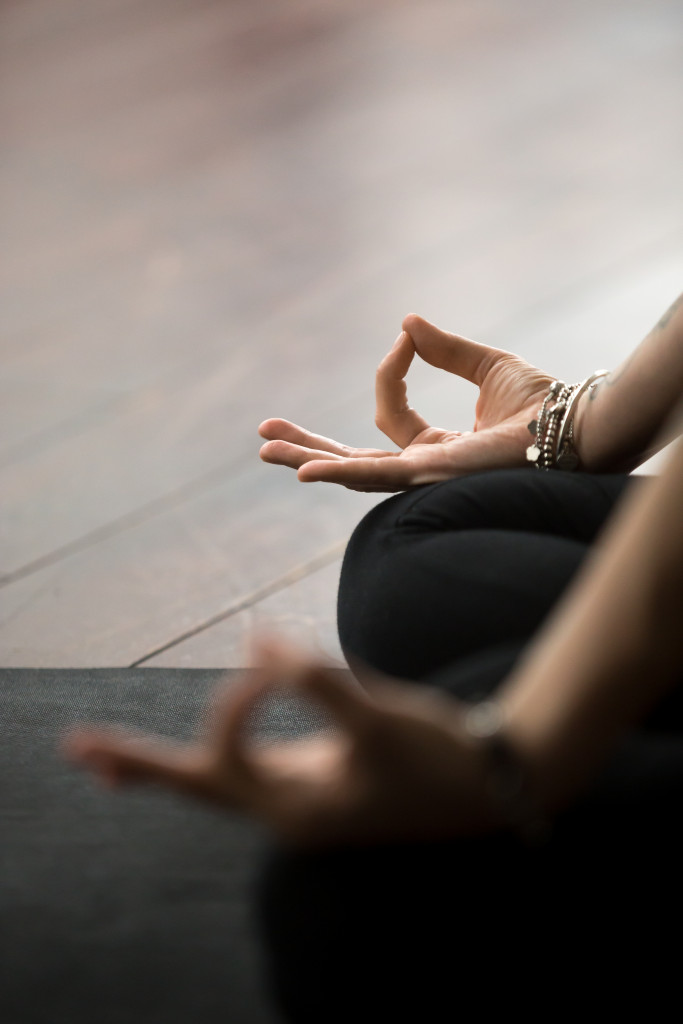 woman in yoga position meditating
