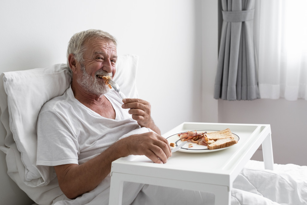 an elderly man eating